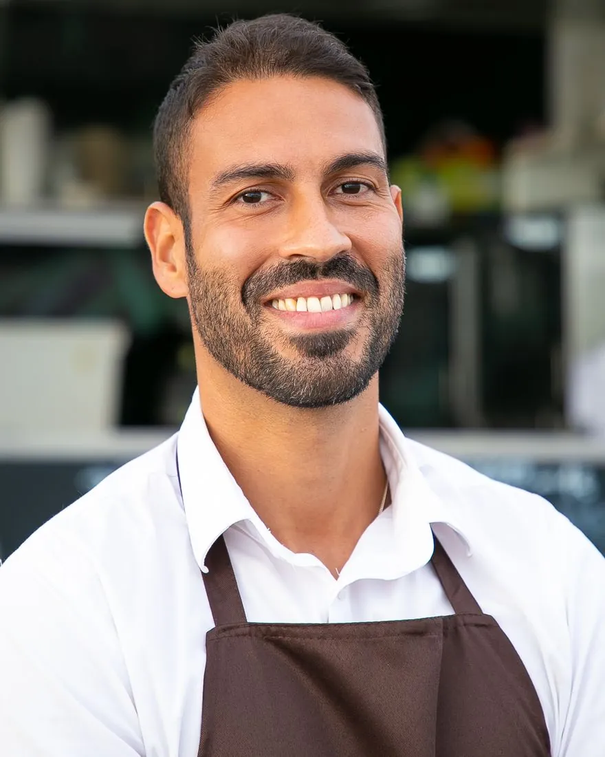 A friendly small business owner smiling
